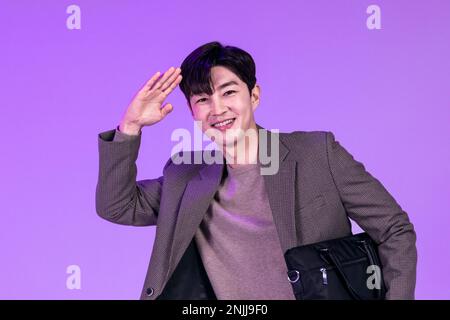 handsome Korean young man leaving work on time with briefcase Stock Photo