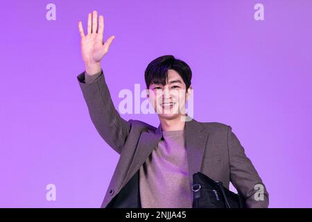 handsome Korean young man leaving work on time with briefcase Stock Photo