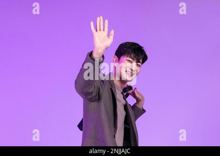 handsome Korean young man leaving work on time with briefcase Stock Photo