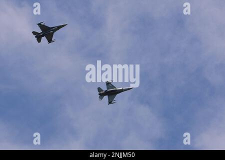 Two U.S. Air Force F-16 Fighting Falcons assigned to the 510th Fighter Squadron fly above Aviano Air Base, Italy, Aug. 8, 2022. The 510th FS is one of two F-16 Fighter Squadrons at Aviano AB that support the base’s many missions, including preparing fighter pilots, controllers, and support personnel to execute U.S. and NATO war plans and contingency operations. Stock Photo