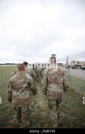 U.S. Army National Guard soldiers assigned to the 1171st Medical Company, Mich., and Reserve Soldiers assigned to the 477th Ground Ambulance, Minn., walk the fence of the Grayling Army Airfield Runway for cold and hot loading training during Northern Strike 22-2, Aug. 08 2022. Northern Strike is designed to challenge over 7,400 service members with multiple forms of training that advance interoperability across multicomponent, multinational and interagency partners. Stock Photo