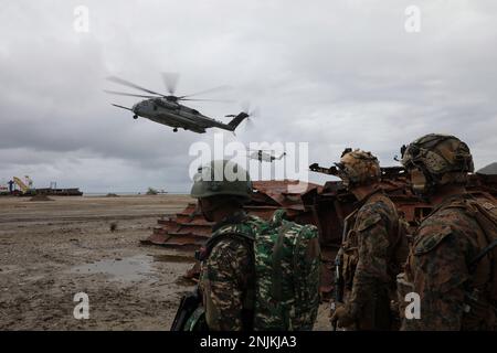 NAVAL BASE HERA, Timor-Leste (Feb. 13, 2023) – U.S. Marines assigned to Battalion Landing Team 2/4, 13th Marine Expeditionary Unit, and Timor-Leste Fuzileiros watch U.S. Marine Corps pilots land CH-53E Super Stallions, during Cooperation Afloat Readiness and Training/Marine Exercise Timor-Leste 2023 at Naval Base Hera, Feb. 13. CARAT/MAREX Timor-Leste is a bilateral exercise between Timor-Leste and the United States designed to promote regional security cooperation, maintain and strengthen maritime partnerships, and enhance maritime interoperability. In its 28th year, the CARAT series is compr Stock Photo