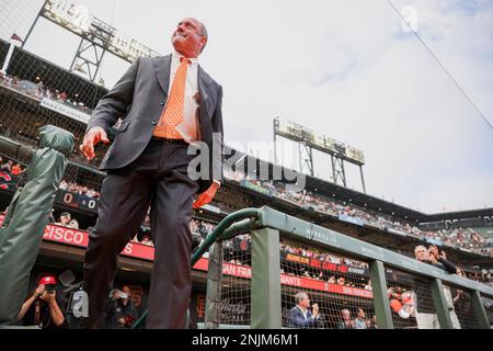 Will Clark looks out from a dugout before a baseball game between