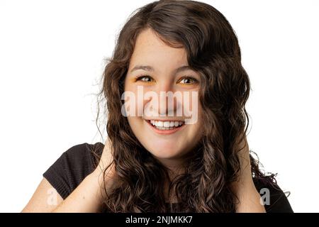 Young woman smiling at the camera on white background Stock Photo