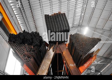 Square and rectangle tubing piles on rack in cold warehouse Stock Photo ...