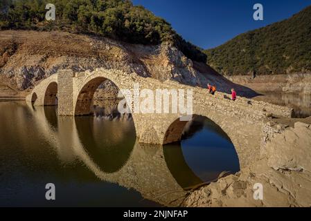 Querós medieval bridge, in the Susqueda reservoir, submerged after the construction of the reservoir and it can be seen in periods of strong drought Stock Photo