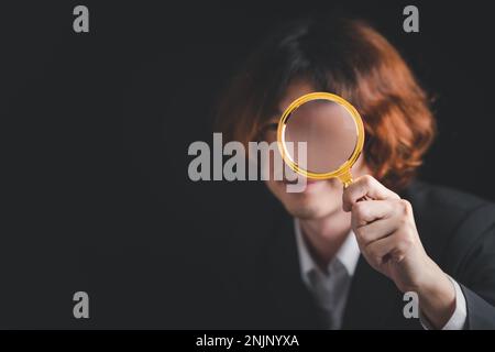 Asian businessman use magnifying glass for CRM, Customer Relationship Management. HR, human resource search personnel. Global structure customer netwo Stock Photo
