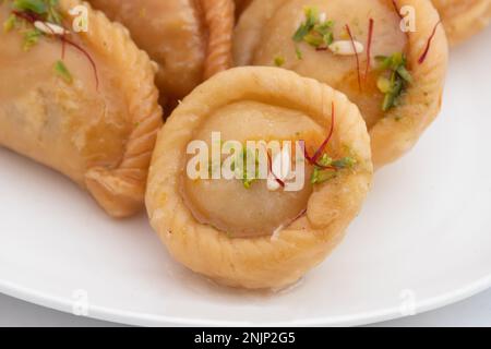 Chandrakala And Gujiya Mithai Also Called Suryakala, Gujia, Pirukiya, Pirukia, Pedakiya, Karanji, Basundi, Gughra Is Made Of Suji Ghee, Mawa Khoya Cha Stock Photo