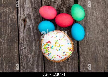 easter eggs lie on a wooden board and easter eggs Stock Photo