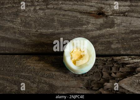 inshell bitten boiled egg lies on a board Stock Photo