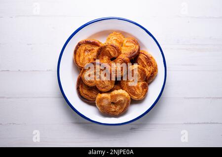 The palmera, palmerita, oreja, orejita, palmita or puff pastry heart is