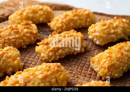 Penellets. Small sweets of various shapes, made from almond and potato dough, and covered with almonds or pine nuts. Stock Photo