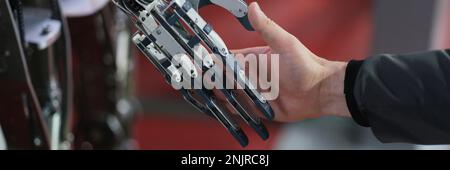 Robot extends its hand to woman for handshake. Artificial intelligence concept business design Stock Photo