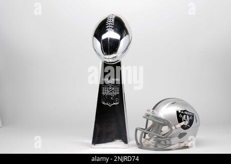 A Las Vegas Raiders helmet and Super Bowl Vince Lombardi