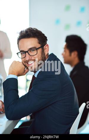 There is much to learn in our general meetings. Portrait of a handsome young businessman in the workplace. Stock Photo