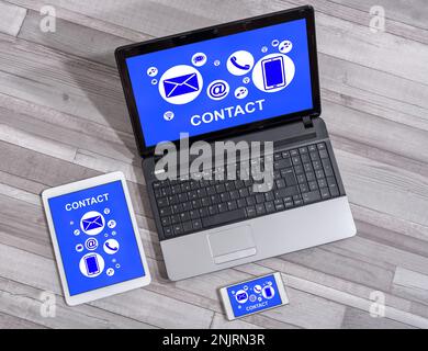 Contact concept shown on different information technology devices Stock Photo