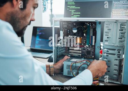 It technician, engineer and computer hardware with a man working to fix or maintenance technology. Hands of expert IT person in office data center for Stock Photo