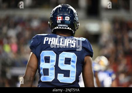 Toronto Argonauts running back Andrew Harris (33) is mobbed by teammates  after scoring a touchdown against the Montreal Alouettes during the first  half of a CFL Eastern Final football game in Toronto