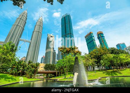 Kuala Lumpur, Malaysia - January 2023: Petronas Twin Towers feature unique steel and glass facade and connected by a skybridge that offers Stock Photo