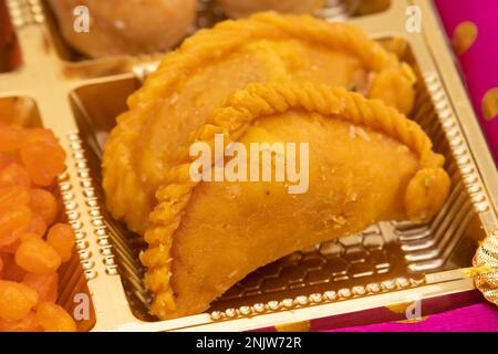 Kesar Gujia Mithai Also Called Kesri Gujiya, Pirukiya, Pirukia, Pedakiya, Karanji, Basundi Gughra Made Of Suji Ghee Stuffed With Mawa Khoya Kesari Cha Stock Photo