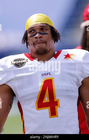 CANTON, OH - JUNE 11: New Jersey Generals running back Kingston Davis (29)  runs the football as Philadelphia Stars safety LaDarius Wiley (4) and  Philadelphia Stars safety Cody Brown (21) combine to