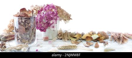 potpourri in a glass jar and bouquet of dry  flowers on white panoramic background Stock Photo