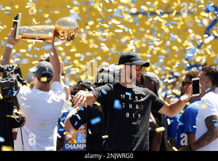 Golden State Warriors' Stephen Curry gestures while holding the Larry O'Brien  trophy during a parade and rally after winning the NBA basketball  championship, in Oakland, Calif. (AP Photo/Marcio Jo …