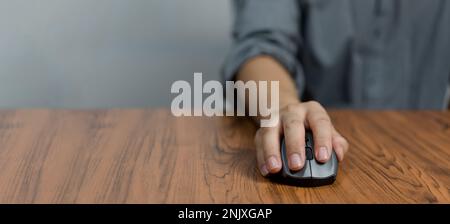 Male hand holding computer mouse with copy space Stock Photo