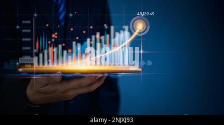 Businessman using tablet online analysis growth graph Stock Market Investments Funds financial data on virtual interface target chart. Intelligent tec Stock Photo