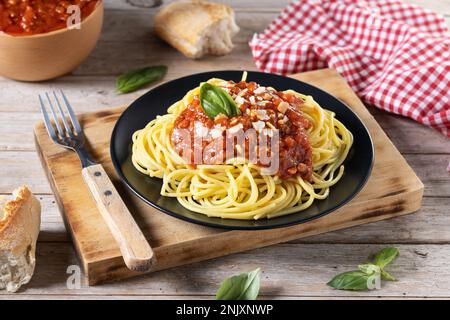 Spaghetti with bolognese sauce on wooden table Stock Photo