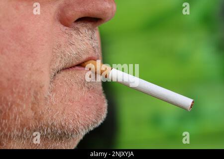 man with a cigarette in his mouth, side view Stock Photo