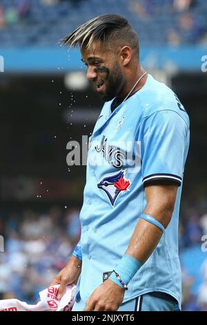 Toronto, Canada, June 5, 2022. Toronto Blue Jays' Santiago Espinal (5),  left, has ‚ÄúThe Home Run Jacket' put on him by Vladimir Guerrero Jr (27),  right, after hitting a three run home