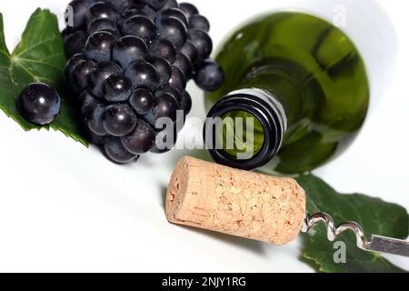 empty wine bottle with cork, leaf and grapes, cutout Stock Photo