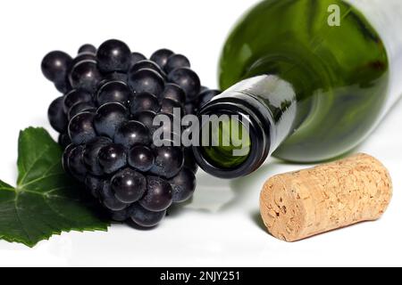 empty wine bottle with cork, leaf and grapes, cutout Stock Photo