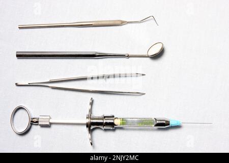 dental probe, mouth mirror and tweezer, instruments of a dentist Stock ...