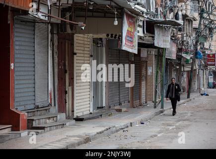 Gaza, Palestine. 23rd Feb, 2023. A Palestinian walks past closed shops in the southern Gaza Strip, in protest against the Israeli military raid on the West Bank city of Nablus. Streets are empty as shops and business areas close following the raid operation by the Israel Amy. According to the Palestinian Ministry of Health, more than 10 Palestinians were killed and more than a hundred injured during the Israeli military raid operation. Credit: SOPA Images Limited/Alamy Live News Stock Photo