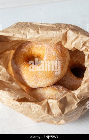 Ring doughnuts, or donuts, in a brown paper bag. Sustainable plastic free recycling packaging. Stock Photo