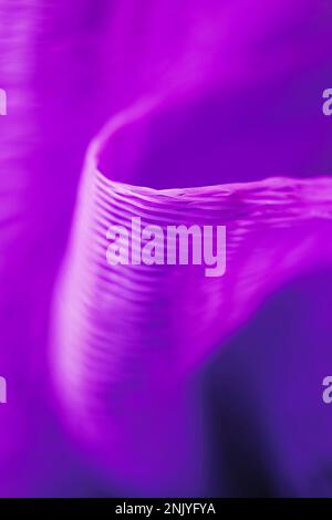 Closeup background of bright purple colored mesh texture with many holes against blurred background Stock Photo