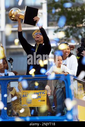 Golden State Warriors' Stephen Curry gestures while holding the Larry O'Brien  trophy during a parade and rally after winning the NBA basketball  championship, in Oakland, Calif. (AP Photo/Marcio Jo …