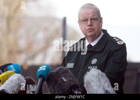 Chief Constable Simon Byrne from the Police Service of Northern Ireland (PSNI) speak to the media outside PSNI headquarters in Belfast, following the shooting of off-duty Detective Chief Inspector John Caldwell on Wednesday evening. Mr Caldwell was shot a number of times by masked men in front of young people he had been coaching. He remains in a critical but stable condition in hospital following the attack. Picture date: Thursday February 23, 2023. Stock Photo