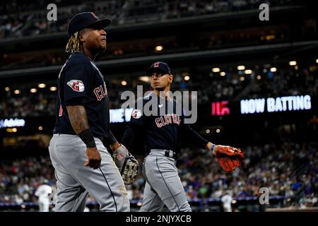 Minnesota Twins starting pitcher Josh Winder walks off the mound after  giving up a solo home run to Cleveland Guardians' Jose Ramirez, rounding  the bases in the background, during the first inning