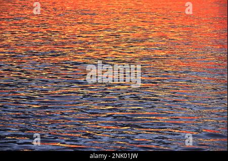 Closeup Colorful Abstract Sunrise Reflection On Danube River in Galati ,Romania Stock Photo