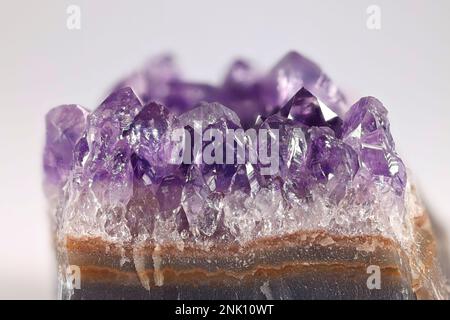 Amethyst is a lilac variety of quartz.  Here crystals exposed from a cut geode. Stock Photo