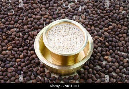 Indian filter coffee in a brass cup Stock Photo