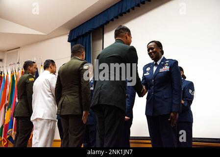 Lt. Col. Tchoia Brown shakes hands with a student during a graduation ceremony for the Inter-American Air Forces Academy, Aug 8, 2022, at Joint Base San Antonio - Lackland. Approximately 200 students from 10 partner nations and the U.S. graduated from IAAFA during B-Cycle graduation. Stock Photo