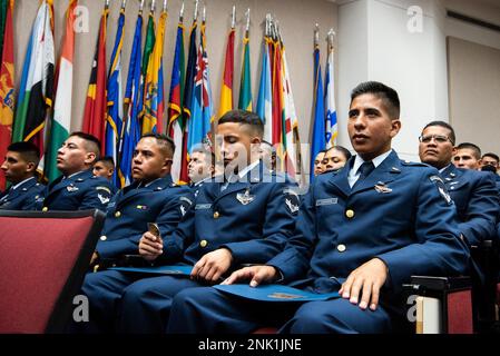 An international military student glances at the coin he received during graduation ceremony for the Inter-American Air Forces Academy, Aug 8, 2022 at Joint Base San Antonio - Lackland. Approximately 200 students from 10 partner nations and the U.S. graduated from IAAFA during B-Cycle graduation. Stock Photo