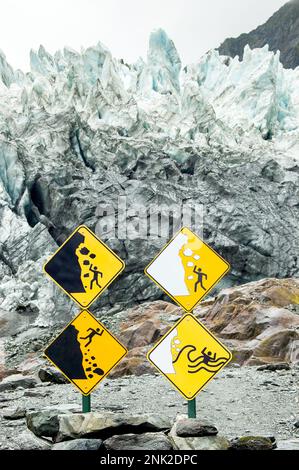 warning sign in franz josef glacier with edge of the glacier in the background, south island new zealand Stock Photo