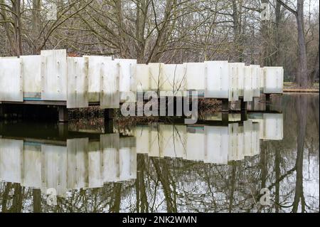 Construction of wooden jetty and plastic screen reflecting in a water pond at the Province Domain, Kessel-Lo, Flemish Brabant, Belgium Stock Photo