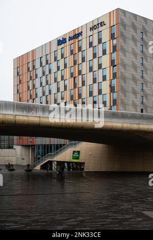 Kessel-Lo, Flemish Brabant, Belgium - Feb 11 2023 - Entrance and square of the railway station with the Ibis Budget hotel in the background Stock Photo