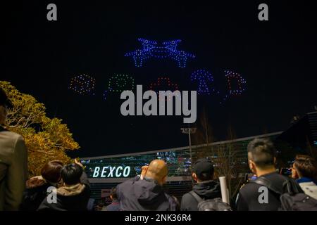 (230223) -- BUSAN, Feb. 23, 2023 (Xinhua) -- People watch a drone light show at the Busan Exhibition & Convention Center (BEXCO) in Busan, South Korea, Feb. 23, 2023.  As part of the Drone Show Korea 2023 held in the city on Thursday, 500 drones put on a light show at night over the exhibition center. The exhibition of unmanned aerial vehicles (UAV) kicked off here to showcase latest technologies and models and to discuss the future of the industry. (Xinhua/Wang Yiliang) Stock Photo